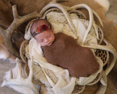 Sioux Falls Newborn posing with Deer Sheds