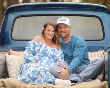 Sioux Falls Maternity Couple Posing in Old Truck