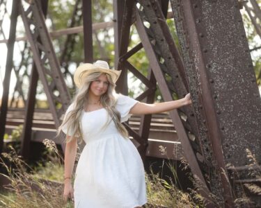 Sioux Falls Senior posing near bridge