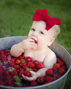 Sioux Falls Girl posing in bucket with strawberries